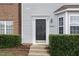 Attractive front entry of townhome with black door and neatly landscaped area at 10947 Pendragon Pl, Raleigh, NC 27614