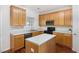 Well-equipped kitchen featuring oak cabinets, modern appliances, and ample counter space at 10947 Pendragon Pl, Raleigh, NC 27614