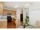 Kitchen with oak cabinets, black appliances, and an island at 10947 Pendragon Pl, Raleigh, NC 27614