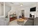 Spacious living room featuring hardwood floors, fireplace, and ample natural light at 10947 Pendragon Pl, Raleigh, NC 27614
