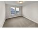 Bright bedroom with carpet flooring and two windows at 110 Shining Amber Way, Franklinton, NC 27525