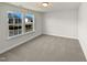 Well-lit bedroom with carpet and two large windows at 110 Shining Amber Way, Franklinton, NC 27525
