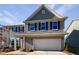Two-story house with gray siding, white garage door, and landscaping at 110 Shining Amber Way, Franklinton, NC 27525