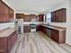 Kitchen with dark brown cabinets, stainless steel appliances, and light flooring at 110 Shining Amber Way, Franklinton, NC 27525