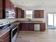 Modern kitchen with stainless steel appliances and dark wood cabinets at 110 Shining Amber Way, Franklinton, NC 27525