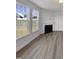 Living room with fireplace and large windows offering natural light at 110 Shining Amber Way, Franklinton, NC 27525