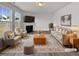 Virtually staged living room with fireplace, neutral decor, and hardwood floors at 110 Shining Amber Way, Franklinton, NC 27525