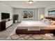 Virtually staged main bedroom with large bed, dresser, and window views at 110 Shining Amber Way, Franklinton, NC 27525
