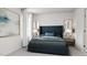 Serene bedroom with a dark blue upholstered bed and nightstands at 1235 Willow Tree Way, Graham, NC 27253