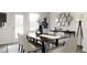 Elegant dining room with a dark wood table and light-colored chairs at 1235 Willow Tree Way, Graham, NC 27253