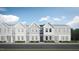 Attractive exterior of a townhome with gray siding and stone accents at 1235 Willow Tree Way, Graham, NC 27253