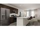 Modern kitchen with island, stainless steel appliances, and dark cabinetry at 1235 Willow Tree Way, Graham, NC 27253