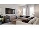 Living room featuring a comfy sofa and large flat-screen TV at 1235 Willow Tree Way, Graham, NC 27253