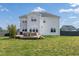 Expansive backyard showcases a deck, furniture, and manicured lawn at 147 E Wellesley Dr, Clayton, NC 27520