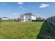 Generous backyard with a wooden privacy fence and well-maintained grass at 147 E Wellesley Dr, Clayton, NC 27520