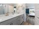 Gray double vanity bathroom with shower and views into bedroom at 147 E Wellesley Dr, Clayton, NC 27520