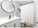 Chic bathroom with a modern vanity, patterned wallpaper, and a shower, designed for a refreshing experience at 147 E Wellesley Dr, Clayton, NC 27520