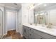 Bathroom with gray cabinets, double sink vanity, and walk-in shower at 147 E Wellesley Dr, Clayton, NC 27520