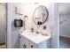 Bathroom vanity features a round mirror, floral wallpaper, and counter decor at 147 E Wellesley Dr, Clayton, NC 27520