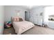 Light-filled bedroom features soft pink accents, a chandelier, and carpeted floors at 147 E Wellesley Dr, Clayton, NC 27520