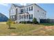 Charming two-story home featuring a welcoming front porch and lush landscaping enhancing its curb appeal at 147 E Wellesley Dr, Clayton, NC 27520