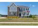 Beautiful two-story home with brick and vinyl siding, complemented by a well-manicured lawn and an inviting front porch at 147 E Wellesley Dr, Clayton, NC 27520