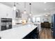 Modern kitchen featuring an island with seating, stainless steel appliances, and direct access to the cozy living space at 147 E Wellesley Dr, Clayton, NC 27520