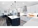 Bright, modern kitchen with white cabinets, a large island, stainless steel appliances, and stylish pendant lighting at 147 E Wellesley Dr, Clayton, NC 27520