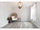 Cozy living room with wicker chair and large window at 147 E Wellesley Dr, Clayton, NC 27520