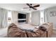 Inviting living room featuring a ceiling fan, large TV, and comfortable sectional sofa at 147 E Wellesley Dr, Clayton, NC 27520