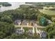 Stunning aerial view of luxurious homes surrounded by lush trees and serene lake at 172 Bonica Creek Dr, Garner, NC 27529