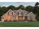 Charming brick home featuring gable accents, well-manicured lawn, and inviting covered porch at 172 Bonica Creek Dr, Garner, NC 27529