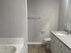Bathroom with granite countertop, white cabinets and a bathtub at 19 Shiloh Dr, Lillington, NC 27546