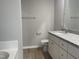 Bathroom with granite countertop, white cabinets and a bathtub at 19 Shiloh Dr, Lillington, NC 27546