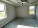 Spacious bedroom with carpet, neutral walls, and two large windows at 19 Shiloh Dr, Lillington, NC 27546