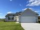 Newly constructed home with gray siding, a two-car garage, and a well-maintained lawn at 19 Shiloh Dr, Lillington, NC 27546
