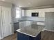 Modern kitchen featuring white cabinets, granite countertops, and an island at 19 Shiloh Dr, Lillington, NC 27546