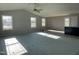 Spacious living room featuring a high ceiling, large windows, and new carpeting at 19 Shiloh Dr, Lillington, NC 27546
