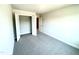 Bright bedroom featuring a spacious closet with double doors and neutral carpeting at 203 Lake Edge Dr, Lillington, NC 27546