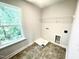 Functional laundry room with tile floors, washer/dryer hookups, and wire shelving at 203 Lake Edge Dr, Lillington, NC 27546