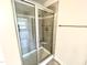 Modern shower with glass door, tiled surround, and built-in seat for convenience at 203 Lake Edge Dr, Lillington, NC 27546