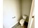 Small powder room with tiled floors, toilet and hardware at 203 Lake Edge Dr, Lillington, NC 27546