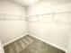 Walk-in closet featuring carpeted flooring and wire shelving for ample storage at 203 Lake Edge Dr, Lillington, NC 27546