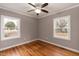 Bright bedroom with hardwood floors and two windows at 212 Hester St, Knightdale, NC 27545