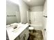 Bathroom featuring a shower-tub combination and gray tiling at 217 Lake Edge Dr, Lillington, NC 27546