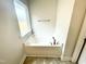 A clean bathtub with chrome faucet and fixtures is illuminated by a window at 217 Lake Edge Dr, Lillington, NC 27546