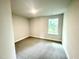 Well-lit bedroom featuring neutral walls and comfortable carpeting at 217 Lake Edge Dr, Lillington, NC 27546