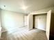 Bright bedroom with neutral carpeting and a closet at 217 Lake Edge Dr, Lillington, NC 27546