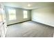 Bedroom with two windows and carpeted floors at 217 Lake Edge Dr, Lillington, NC 27546