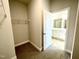 Walk-in closet with shelving leading to the bathroom featuring double vanity at 217 Lake Edge Dr, Lillington, NC 27546